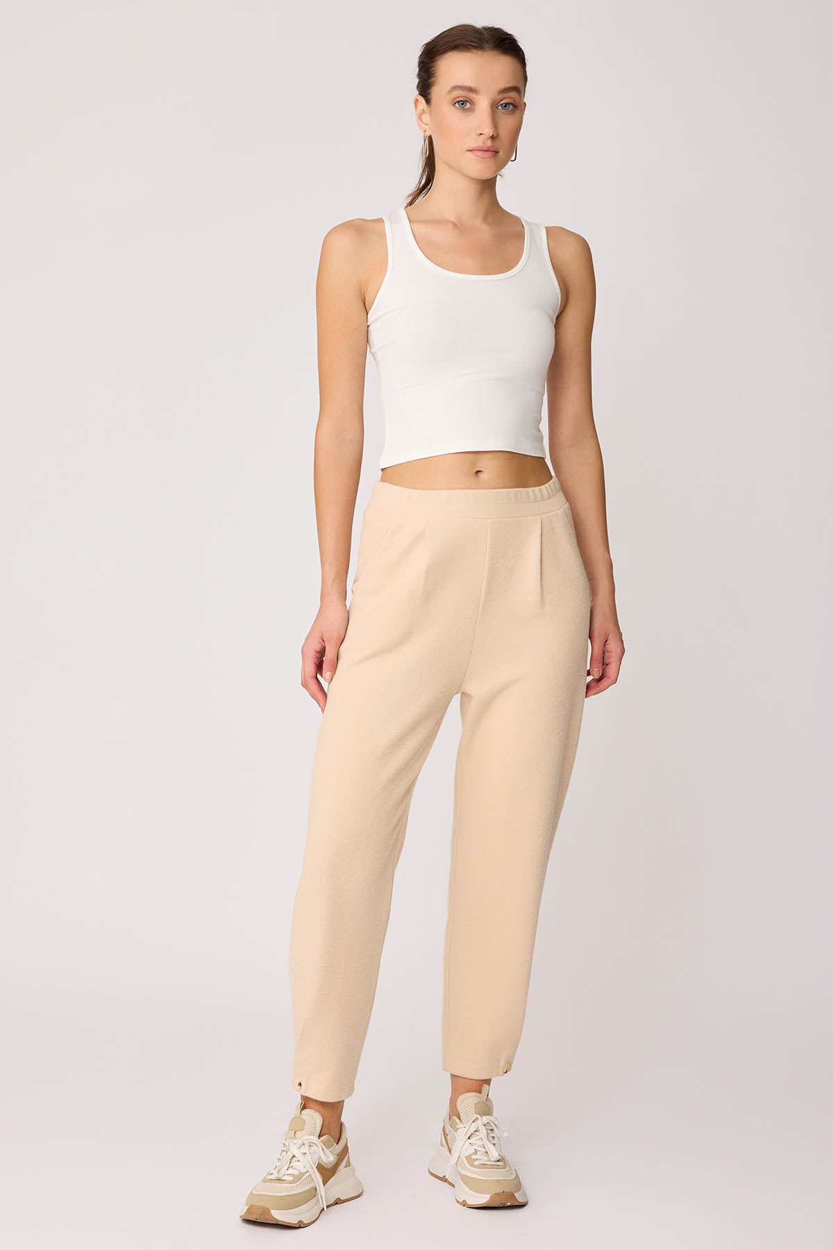 KNITTED TROUSERS WITH CUTOUT BUTTONS
