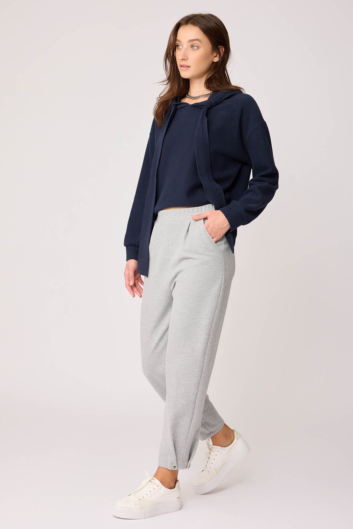 KNITTED TROUSERS WITH CUTOUT BUTTONS