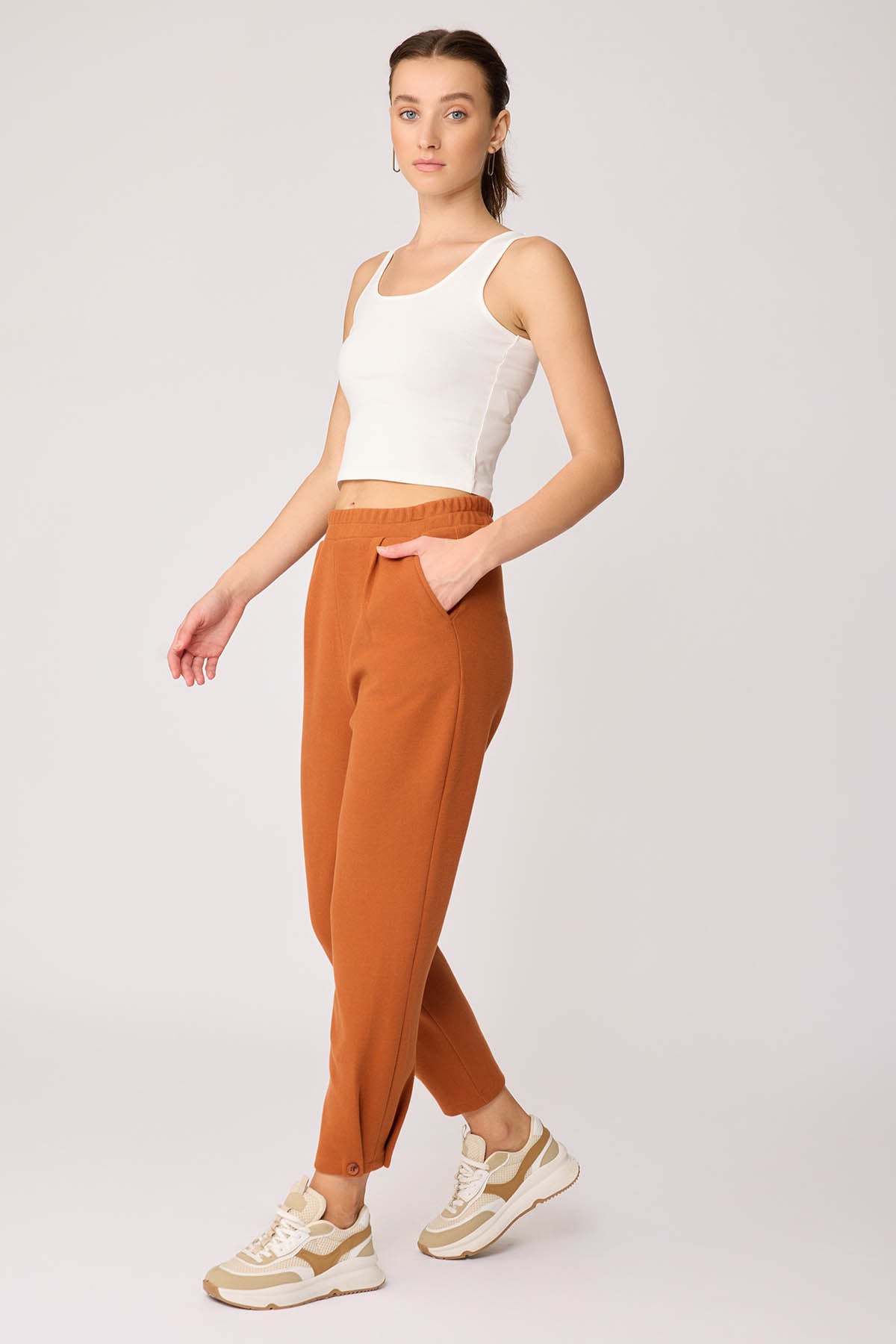 KNITTED TROUSERS WITH CUTOUT BUTTONS