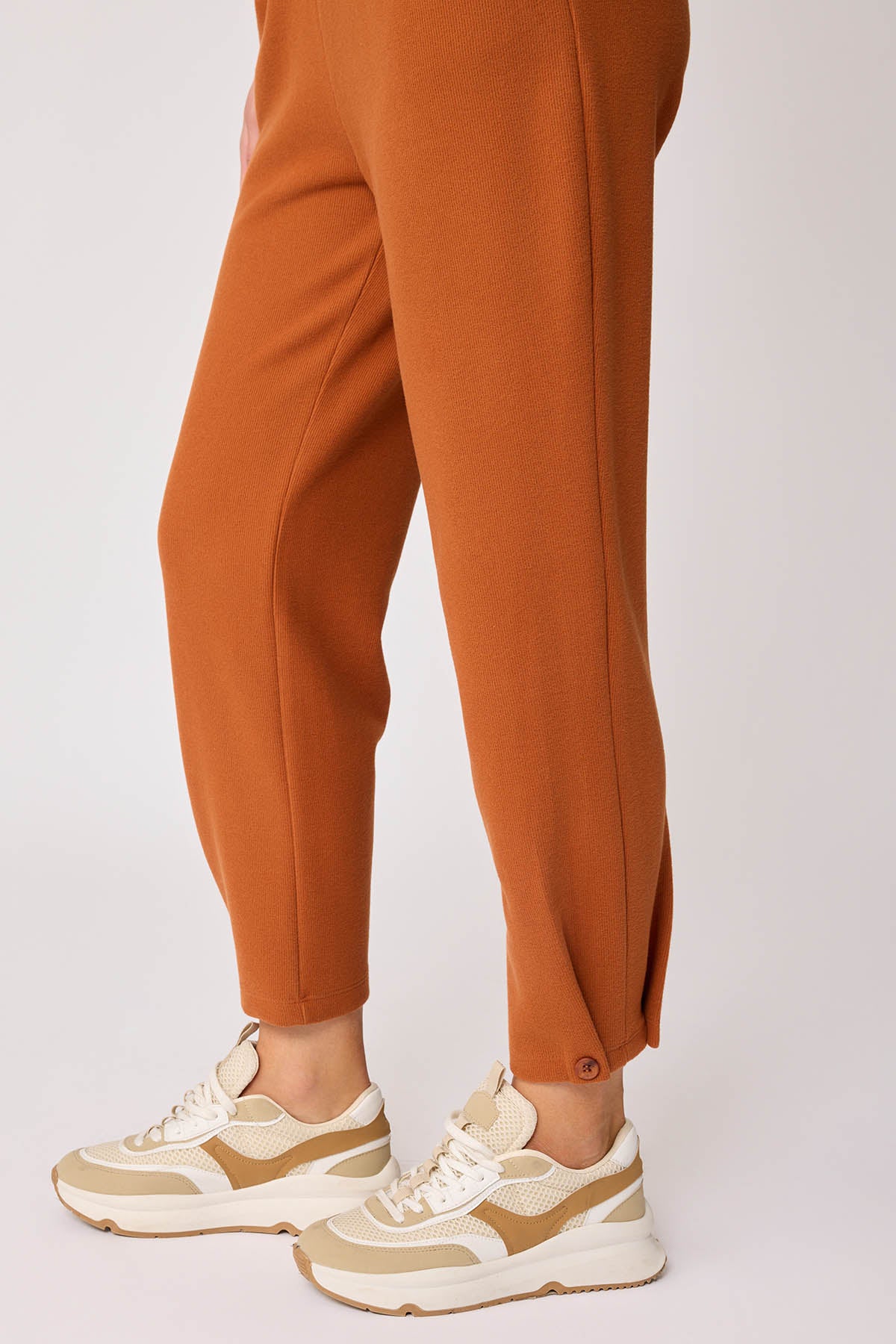 KNITTED TROUSERS WITH CUTOUT BUTTONS