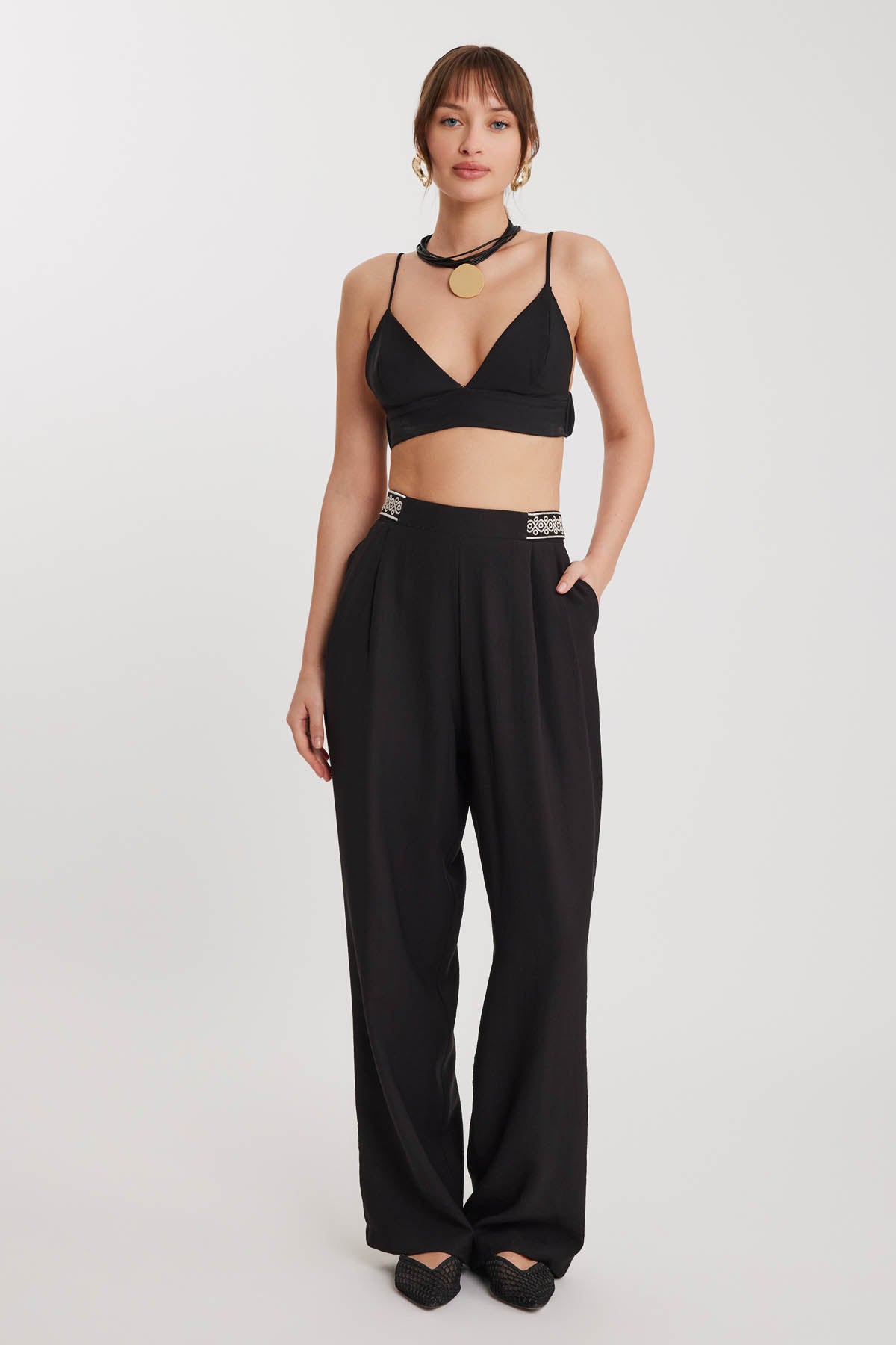 PLEATED TROUSERS WITH ETHNIC PATTERNED WAIST