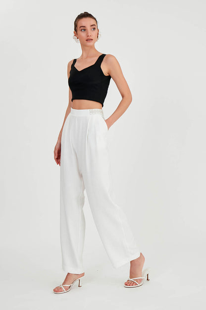 PLEATED TROUSERS WITH ETHNIC PATTERNED WAIST
