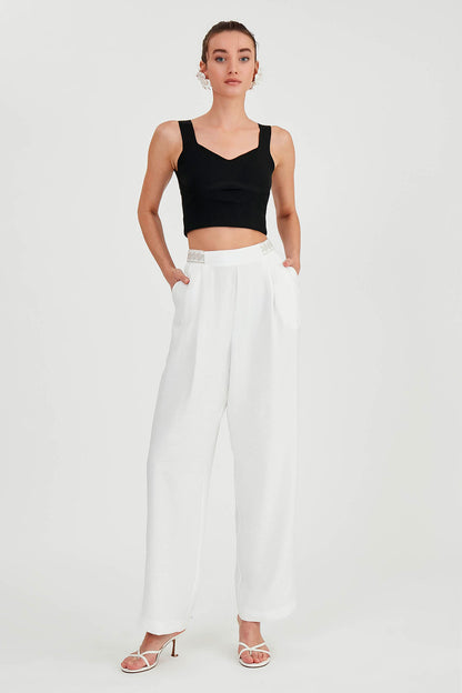 PLEATED TROUSERS WITH ETHNIC PATTERNED WAIST