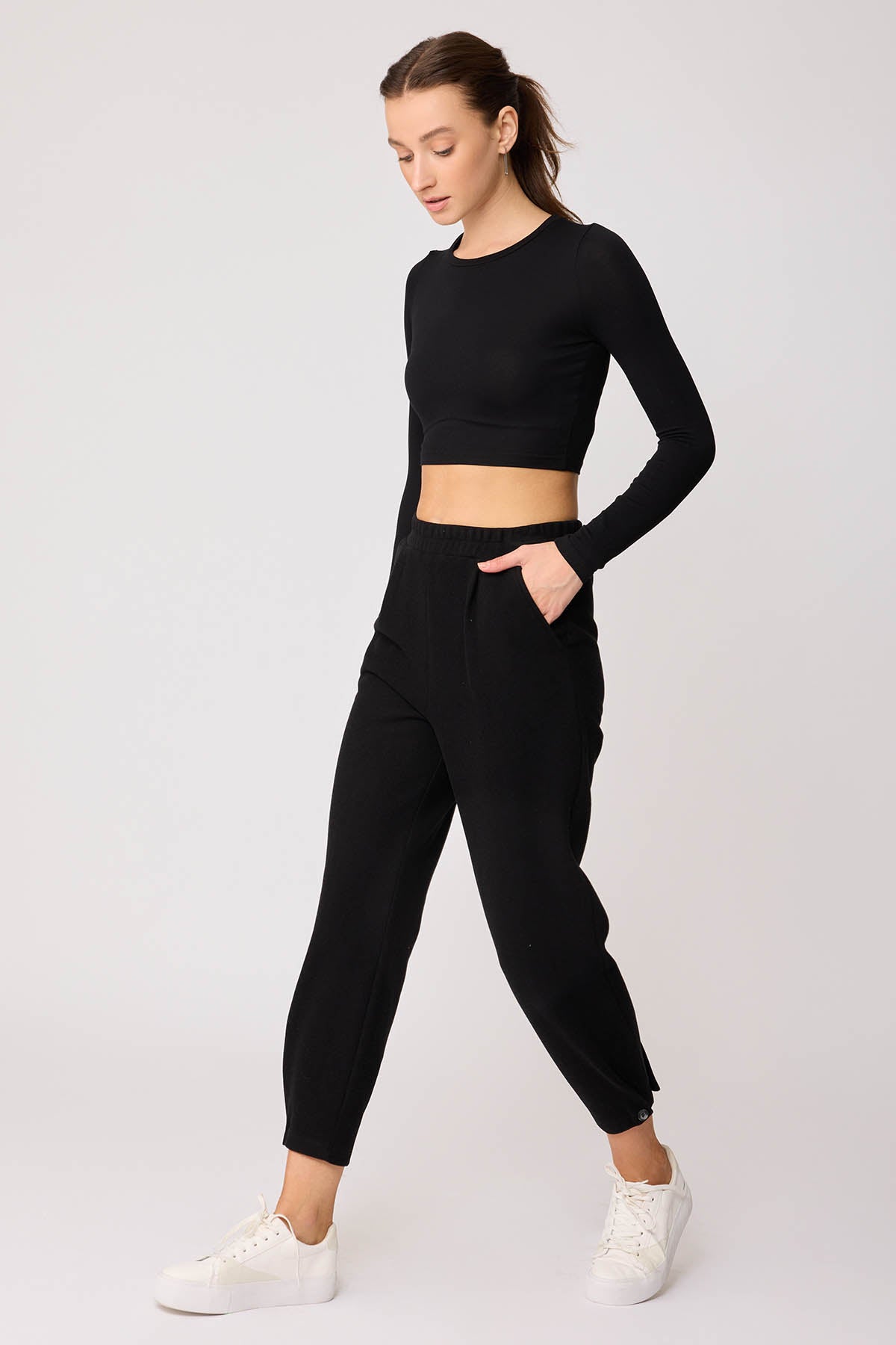 KNITTED TROUSERS WITH CUTOUT BUTTONS