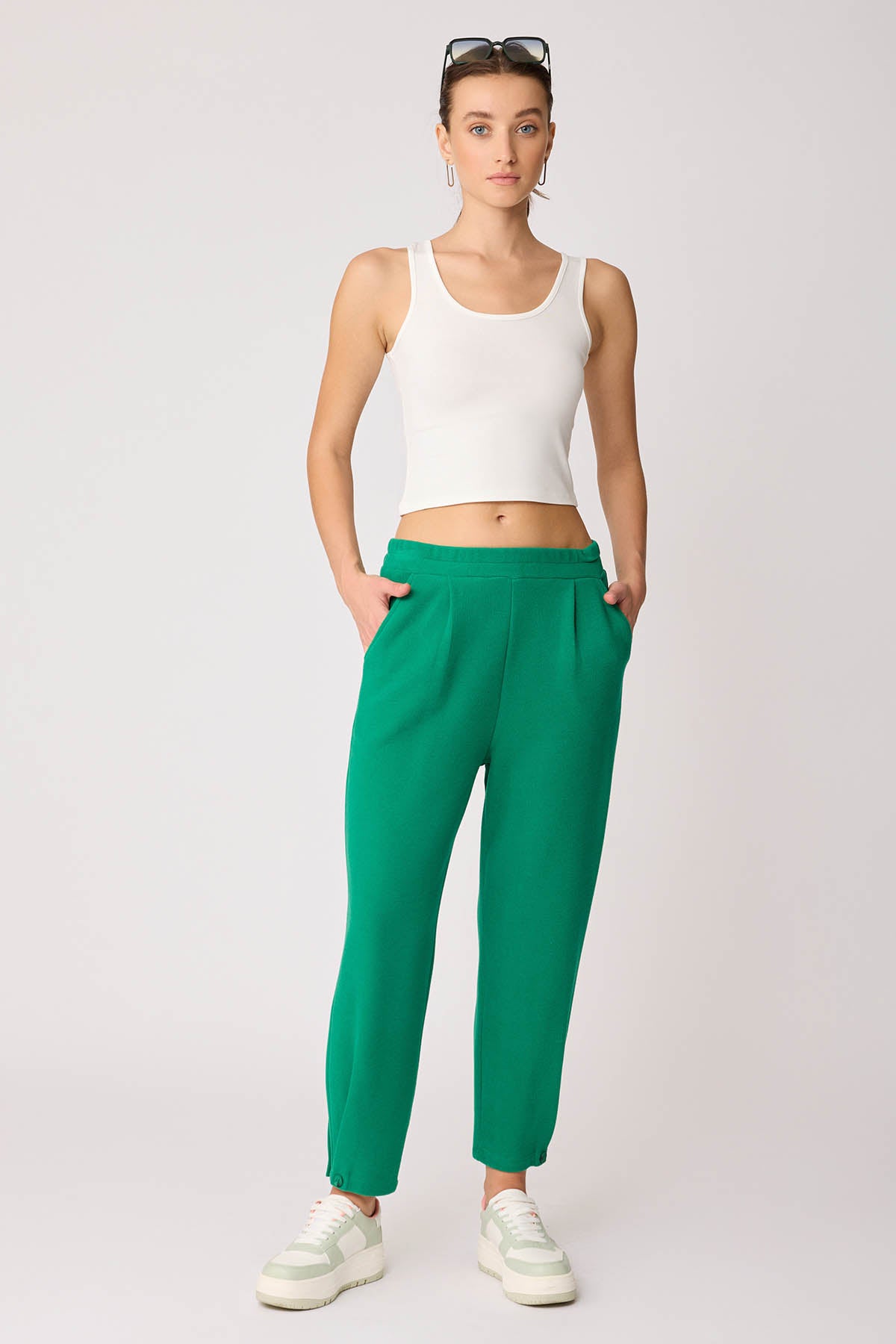KNITTED TROUSERS WITH CUTOUT BUTTONS