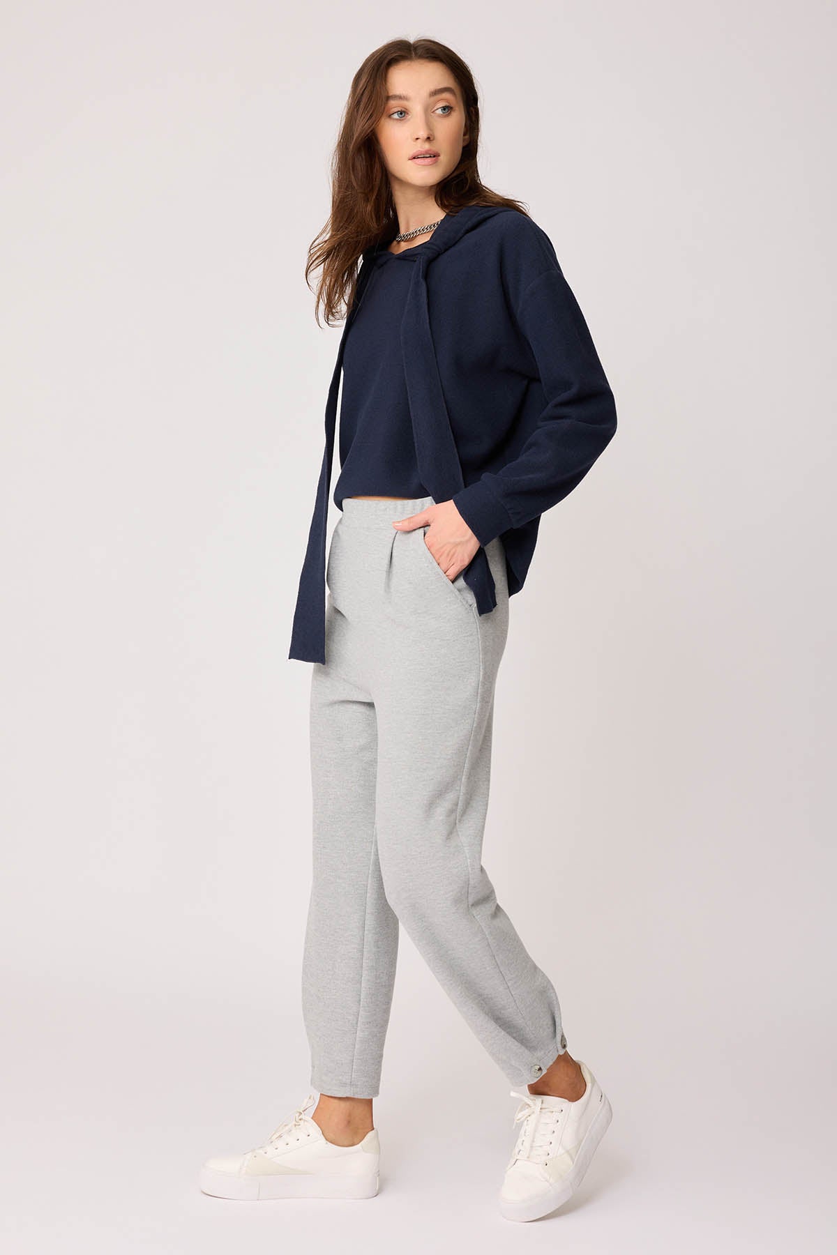 KNITTED TROUSERS WITH CUTOUT BUTTONS
