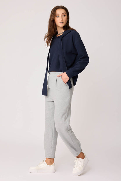 KNITTED TROUSERS WITH CUTOUT BUTTONS