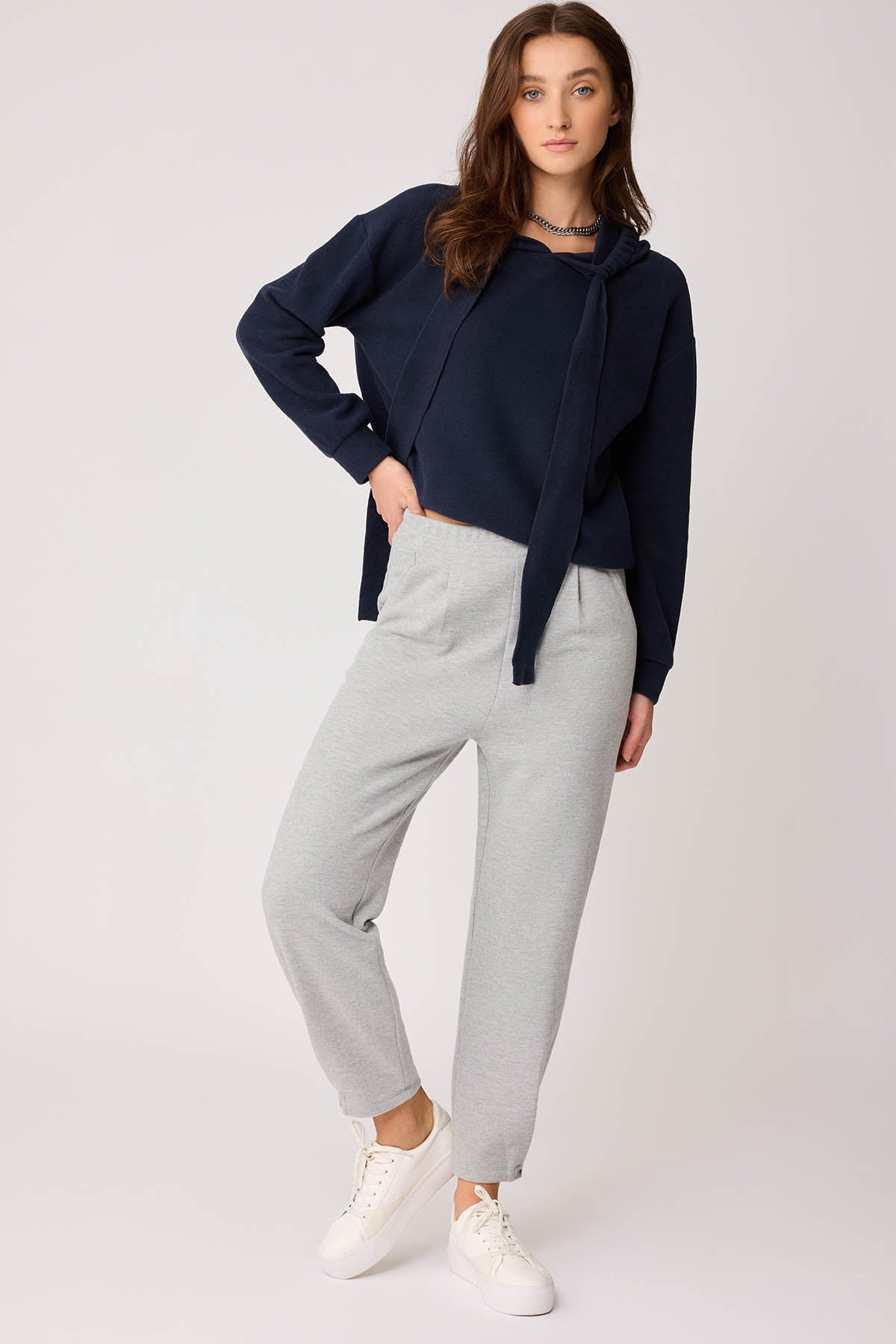 KNITTED TROUSERS WITH CUTOUT BUTTONS
