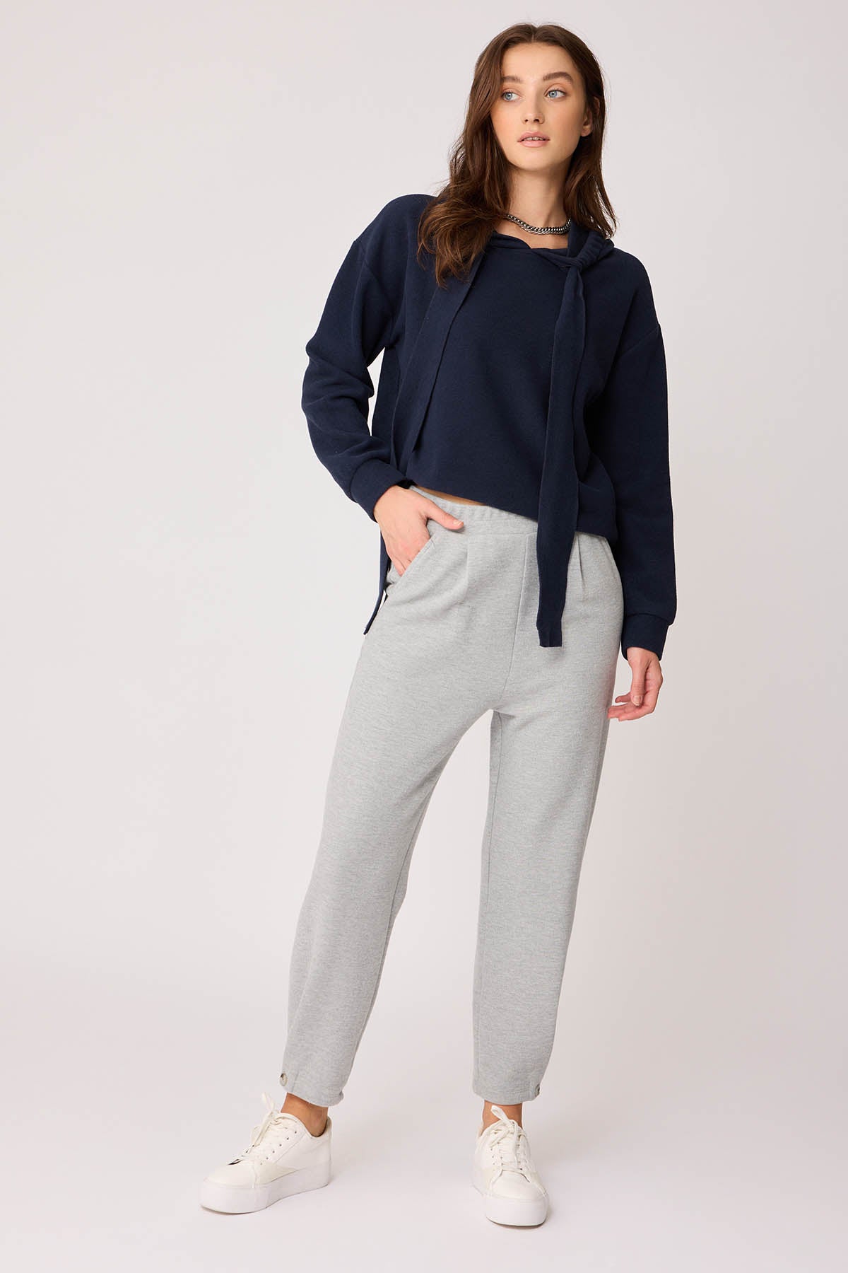 KNITTED TROUSERS WITH CUTOUT BUTTONS