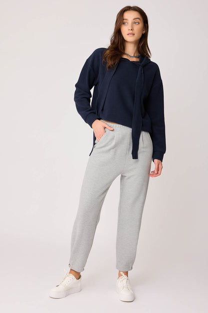KNITTED TROUSERS WITH CUTOUT BUTTONS