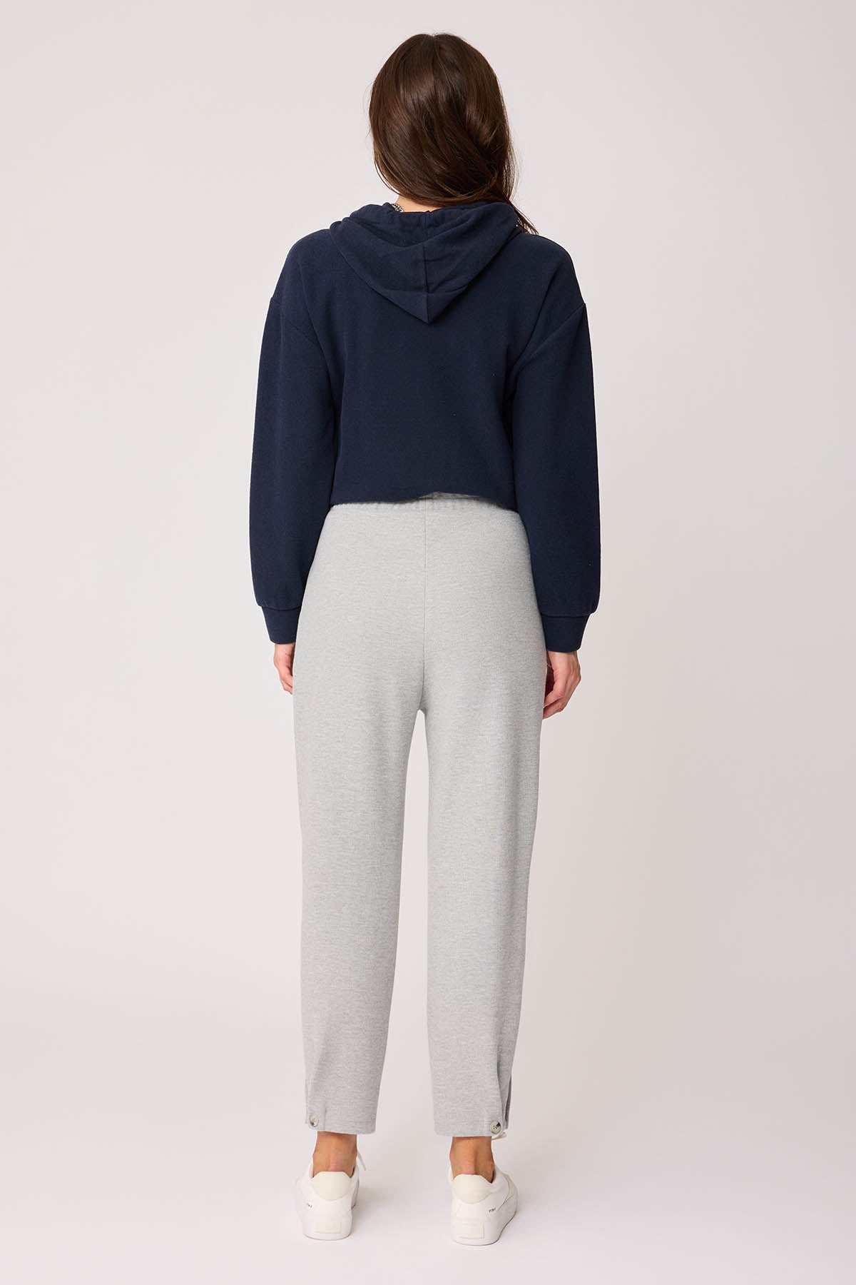 KNITTED TROUSERS WITH CUTOUT BUTTONS