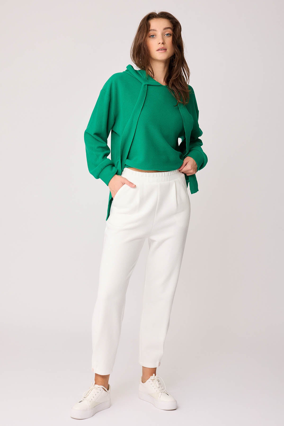 KNITTED TROUSERS WITH CUTOUT BUTTONS