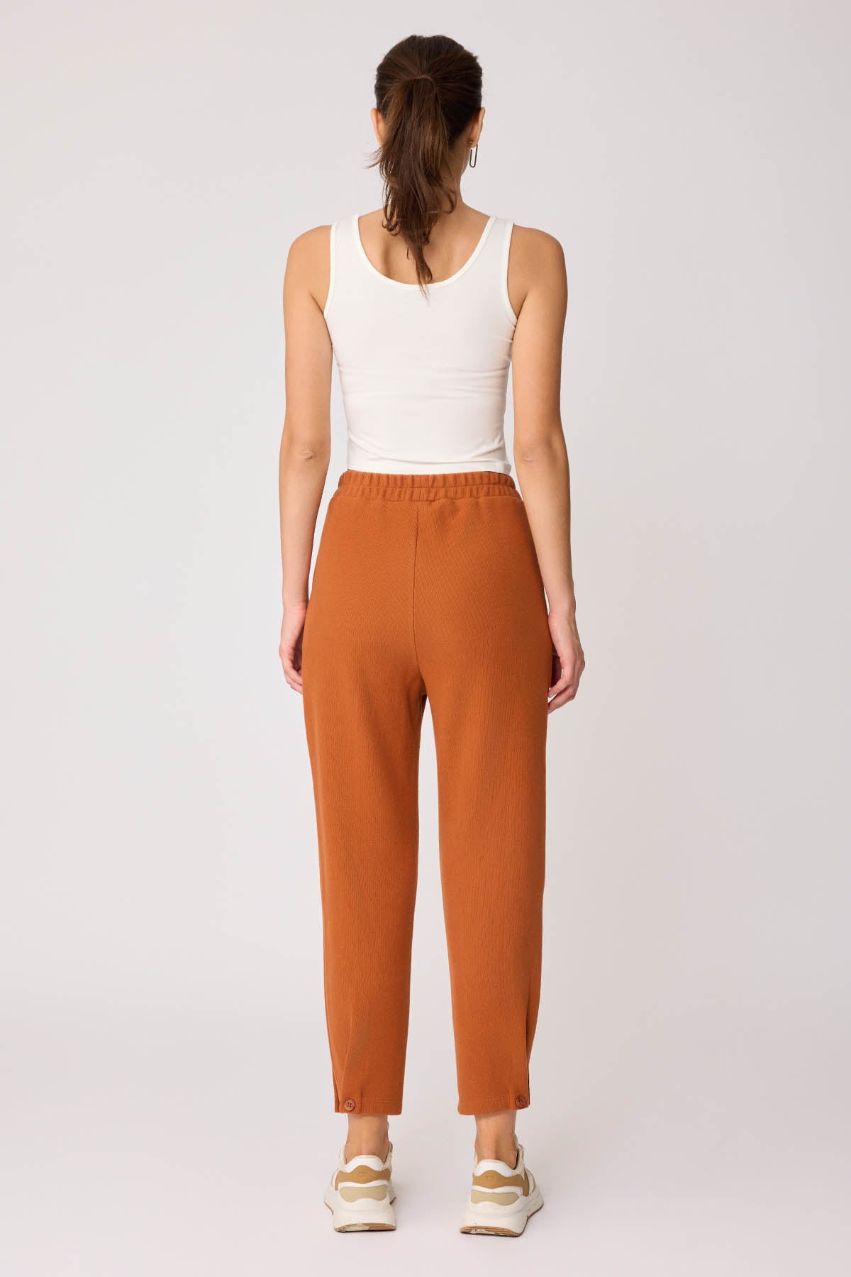 KNITTED TROUSERS WITH CUTOUT BUTTONS