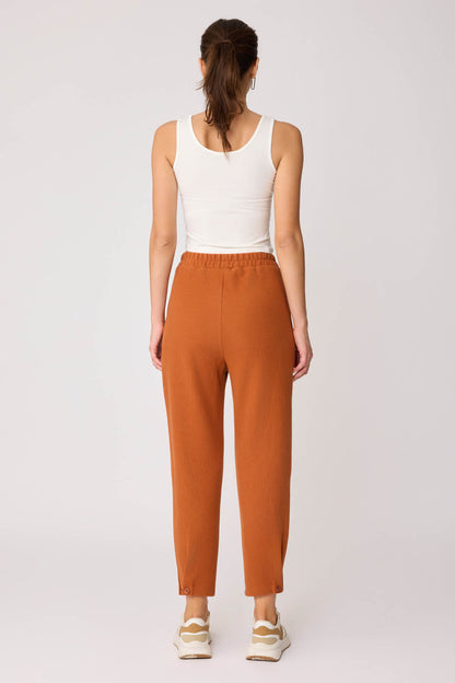 KNITTED TROUSERS WITH CUTOUT BUTTONS