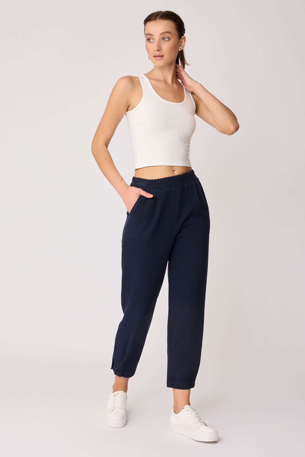 KNITTED TROUSERS WITH CUTOUT BUTTONS