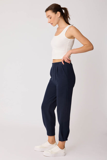 KNITTED TROUSERS WITH CUTOUT BUTTONS