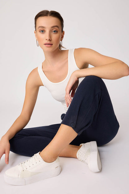 KNITTED TROUSERS WITH CUTOUT BUTTONS