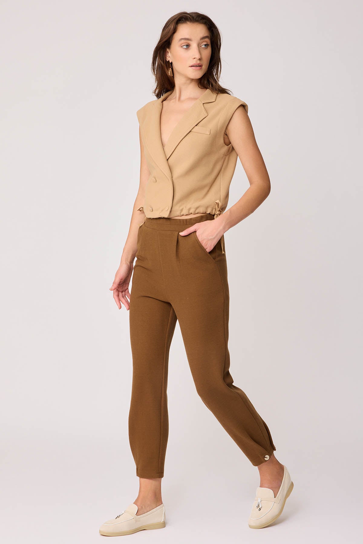 KNITTED TROUSERS WITH CUTOUT BUTTONS